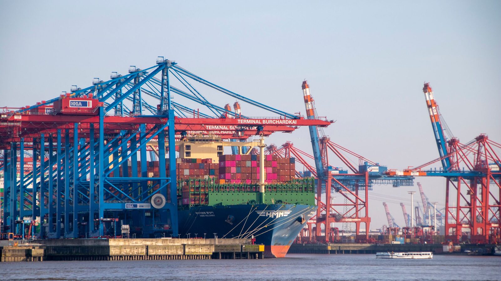 Gantry cranes loading a container ship at a busy port