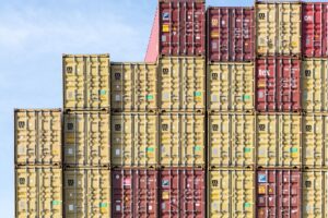 Stacked shipping containers representing why a Brazilian buyer disappeared